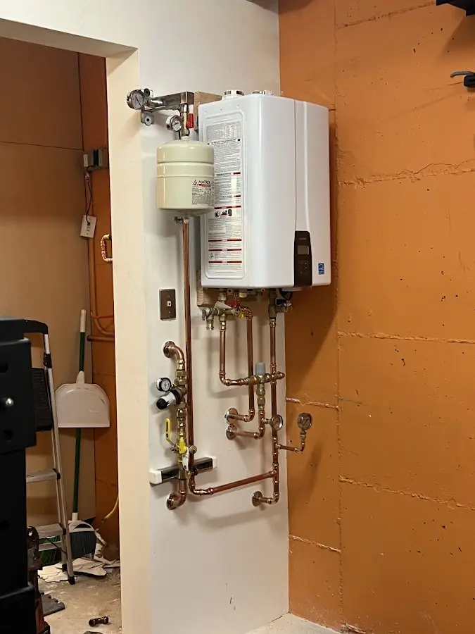 Plumbing technician inspecting water heater connections in San Clemente